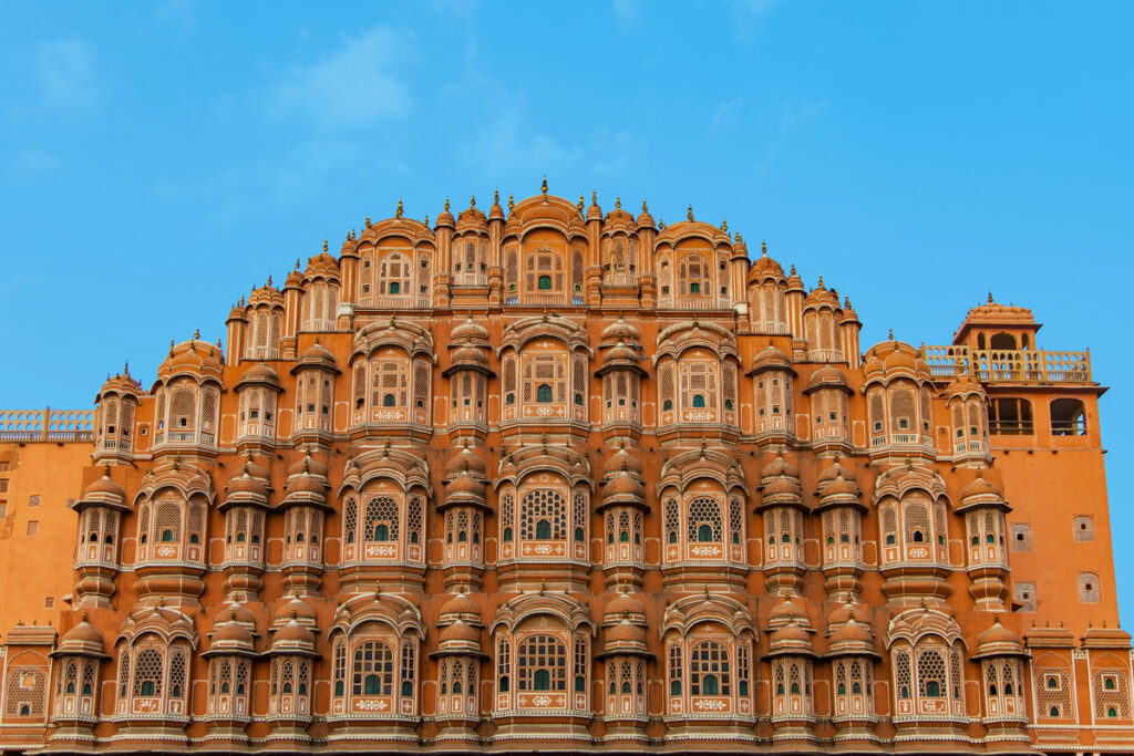 Hawa Mahal’s intricate sandstone facade beneath a blue sky in Jaipur, India
