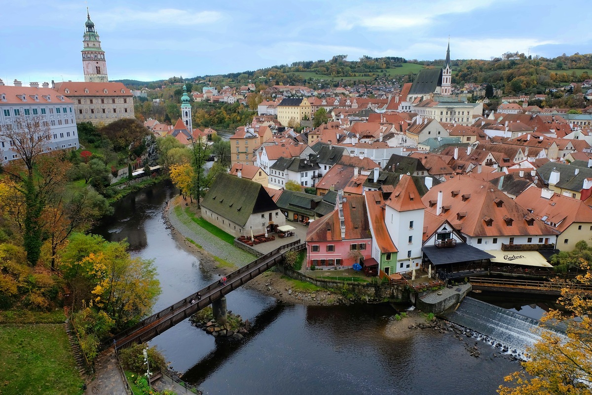 Red-roofed buildings, the Vltava River and castle tower in Český Krumlov