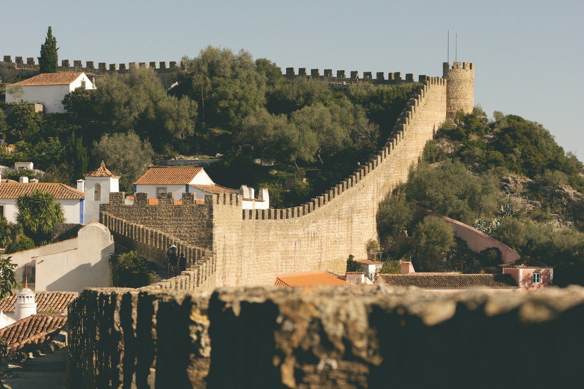 The castle and medieval walls above the white houses of Óbidos, Portugal