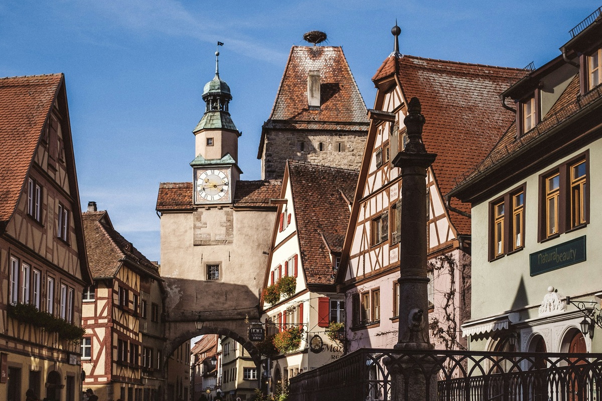 A cobbled street and historic clock tower in Rothenburg ob der Tauber