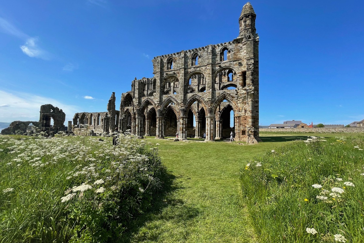 Whitby Abbey’s ruined Gothic arches beneath a bright blue sky