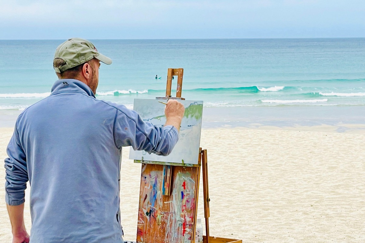 Artist Andrew Barrowman paints outdoors overlooking the sea